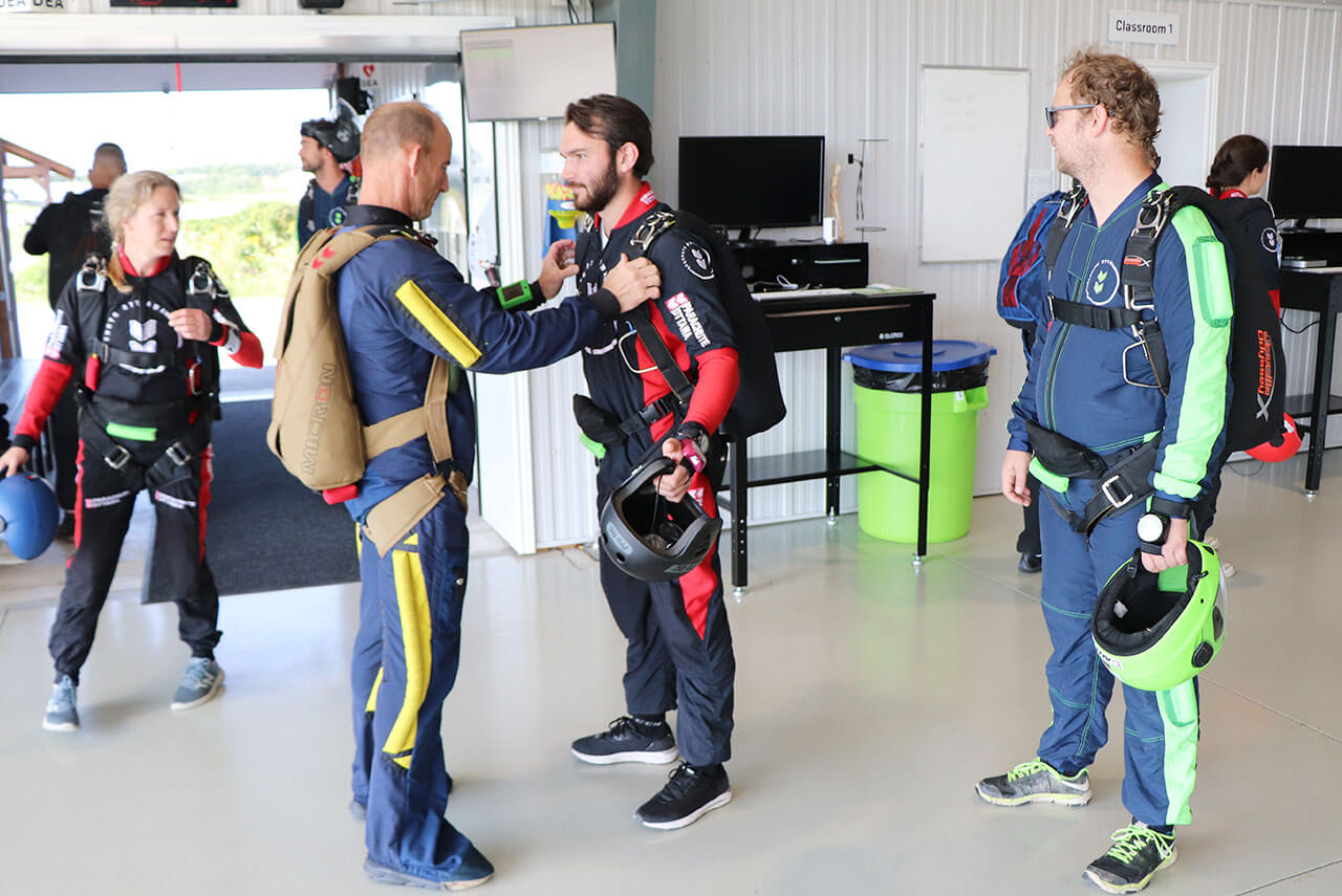 Tandem Skydiving student getting trained and geared up in the hangar at Parachute Ottawa skydiving centre in Canada