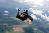 Licensed skydiver in freefall over Parachute Ottawa in Canada