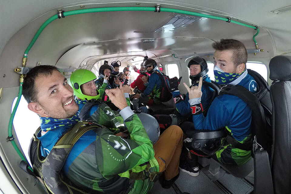 A group of skydivers in an aircraft on the ride of up to altitude at Parachute Ottawa