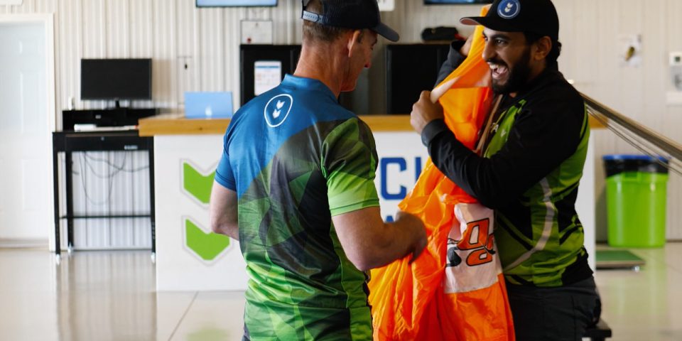 pff student folds parachute in hangar with instructor