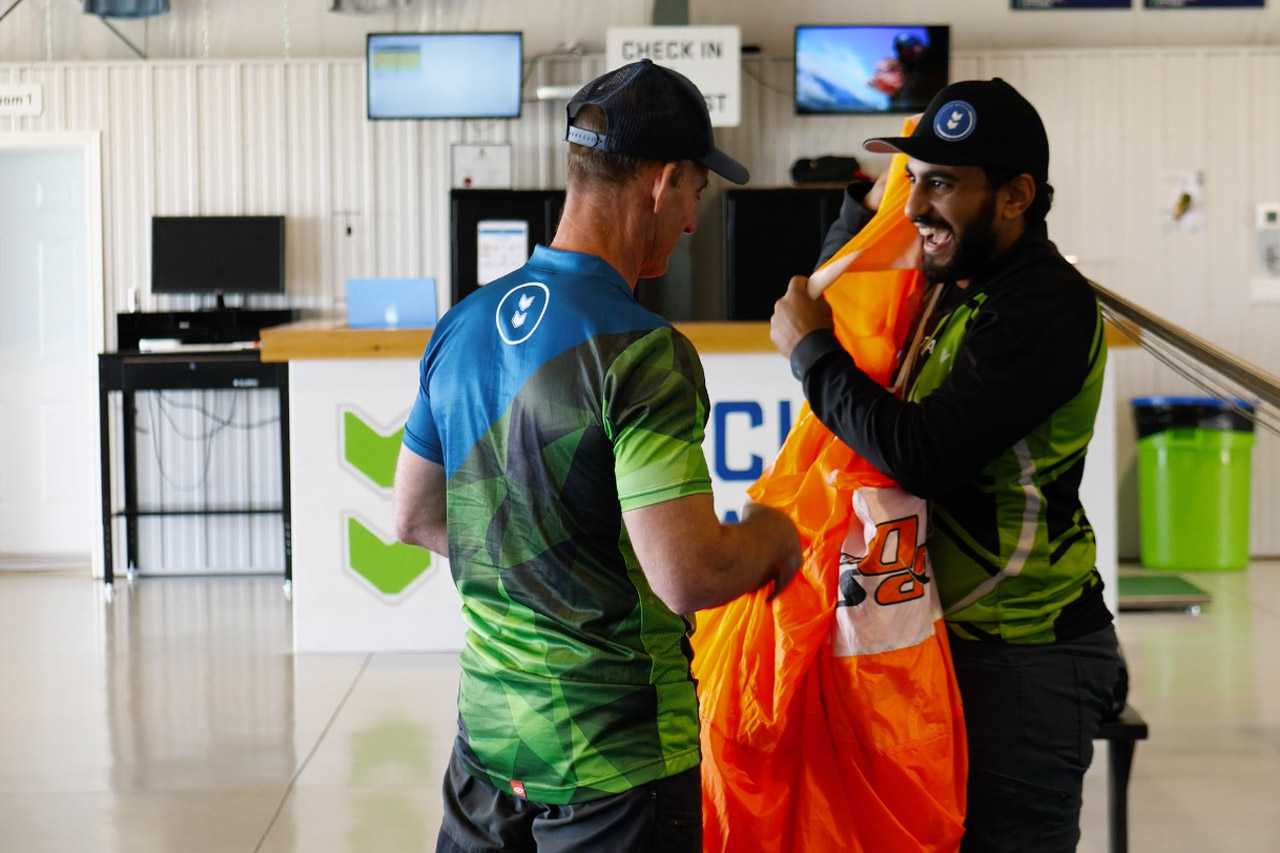 pff student folds parachute in hangar with instructor