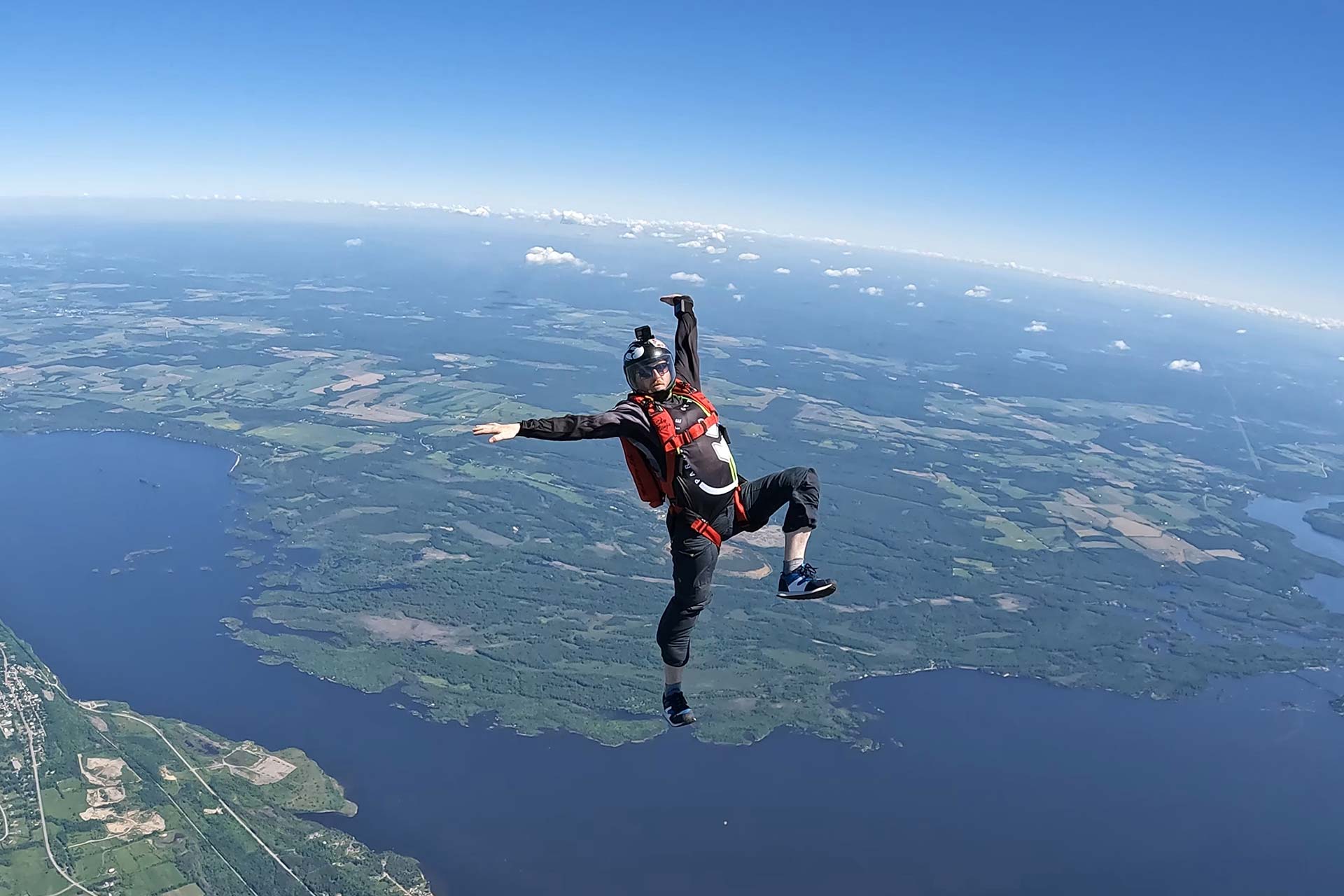 Licensed skydiver in freefall over Parachute Ottawa in Canada