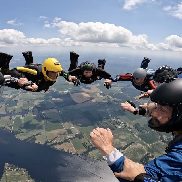 Licensed skydivers in freefall making a formation over Parachute Ottawa