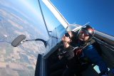 Tandem skydiving student and instructor exiting an airplane at Parachute Ottawa in Ontario