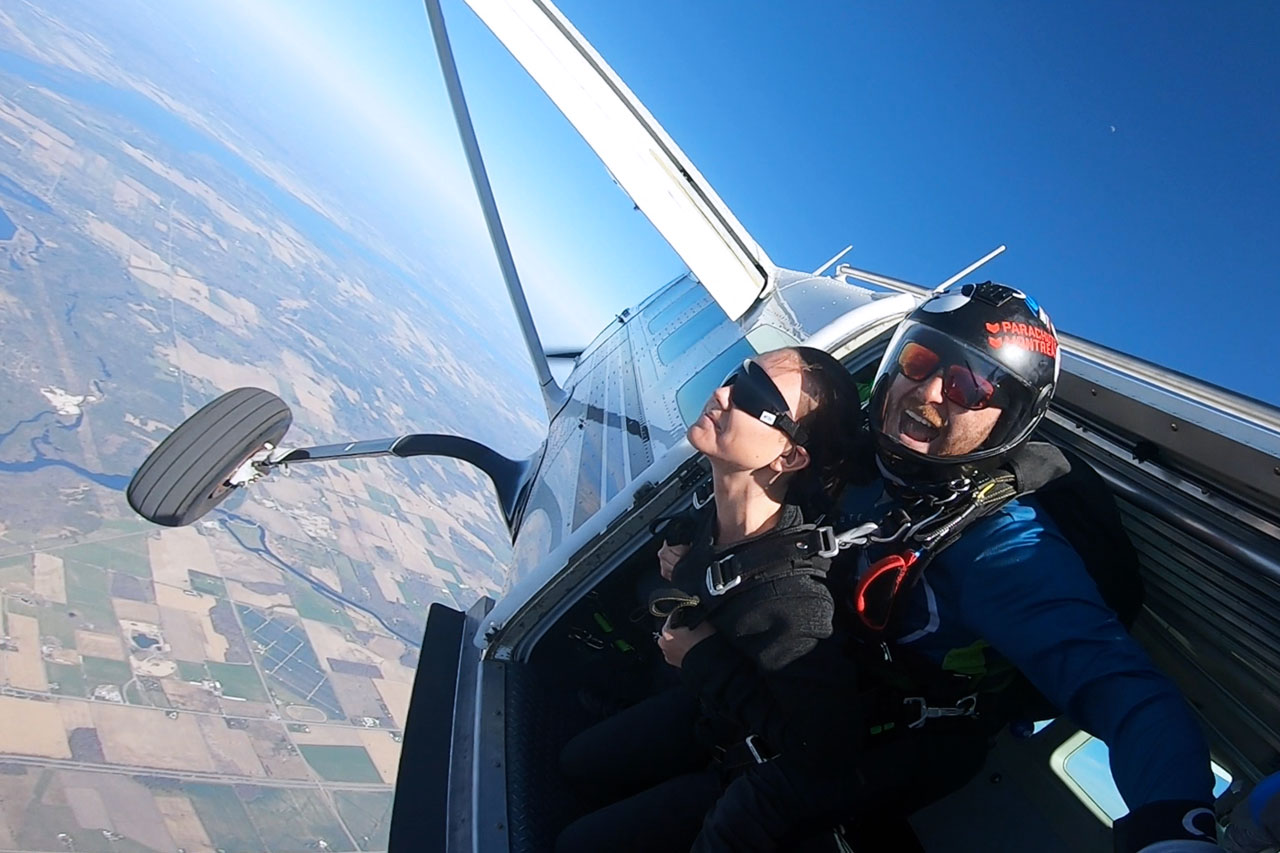 Tandem skydiving student and instructor exiting an airplane at Parachute Ottawa in Ontario