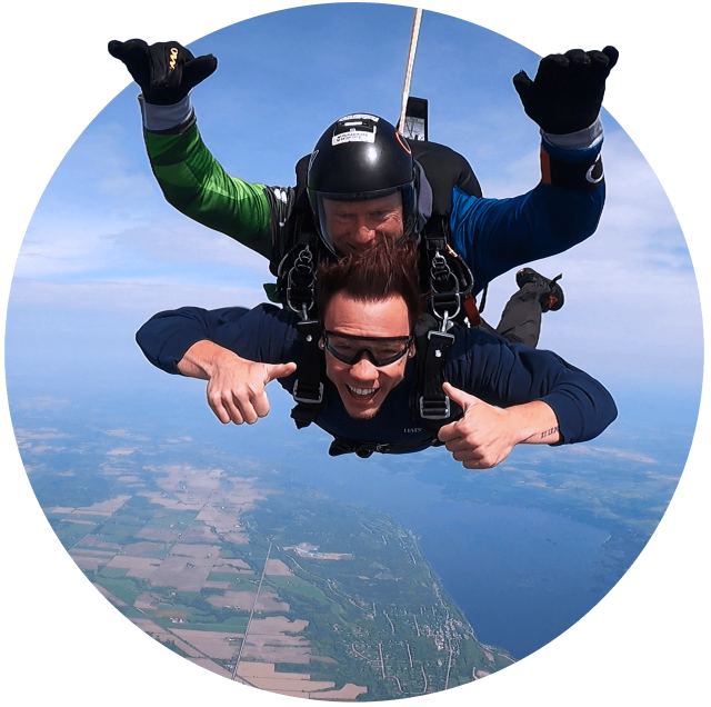 Tandem skydiving student and instructor in freefall over Parachute Ottawa in Ontario, Canada